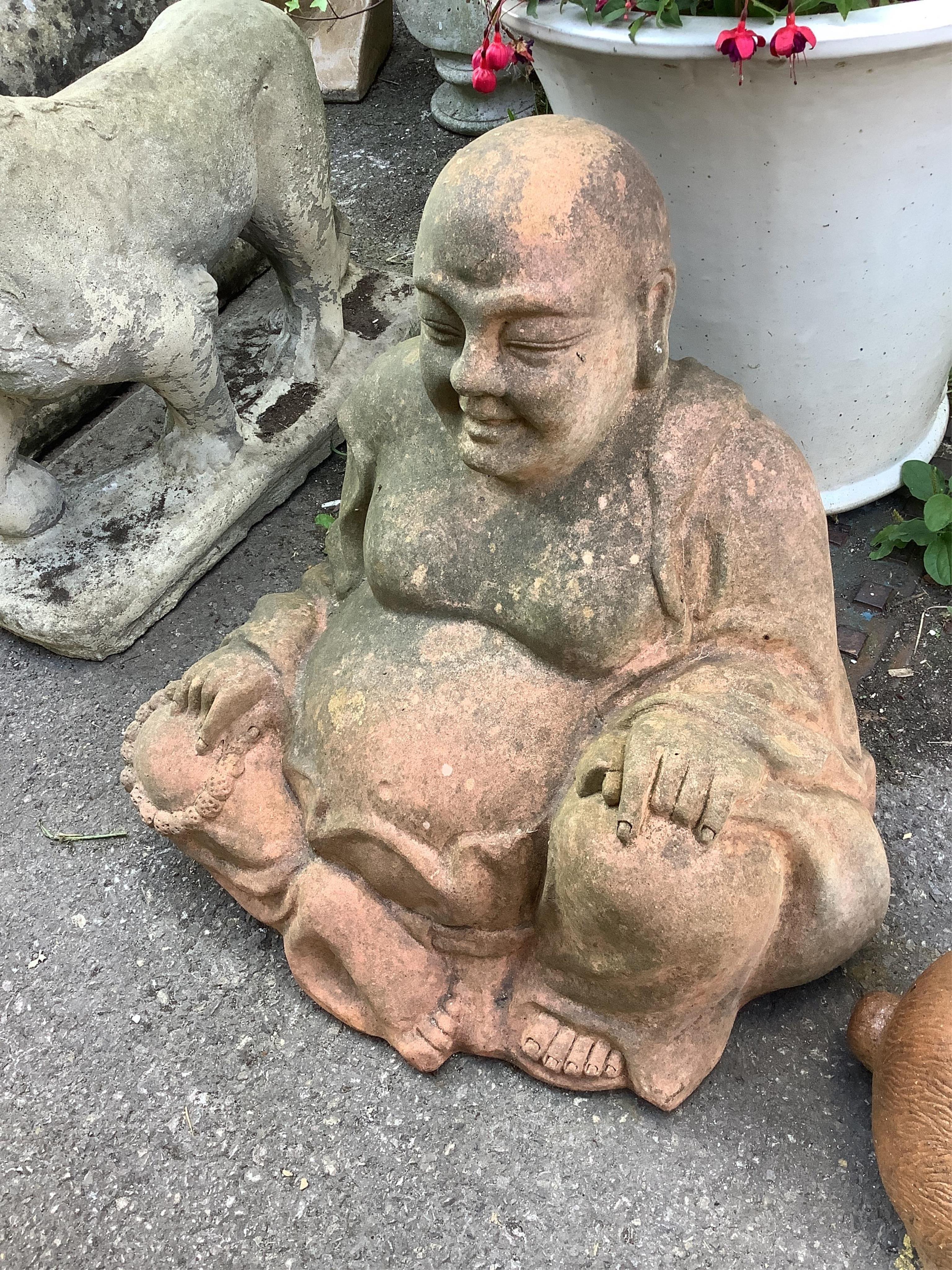 A terracotta model of a seated Buddha, height 55cm, and a model of a rabbit garden ornament, length 48cm. Condition - fair